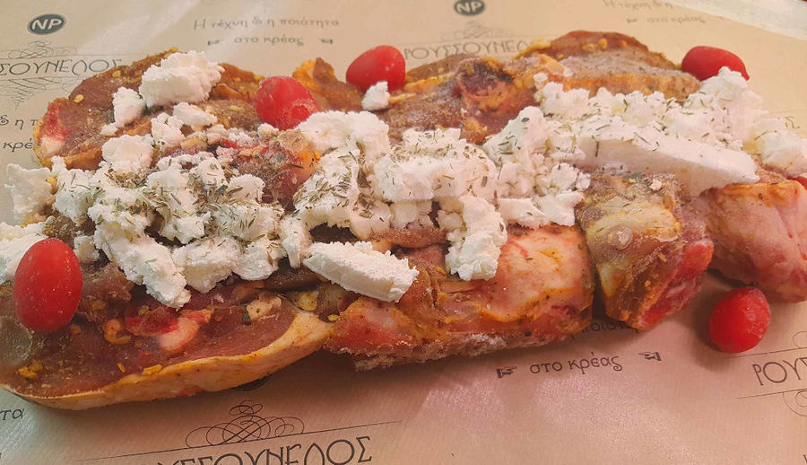 local lamb with spices, feta, tomato and garlic at 'Roussounelos Meat Market'